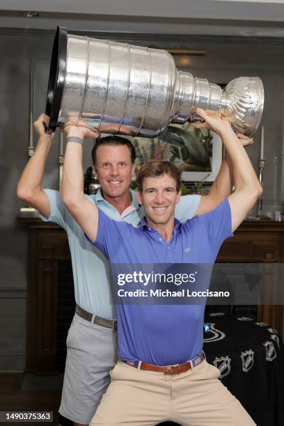 Brad Richards and Eli Manning with the Stanley Cup during the 2023 NHL Stanley Cup Tour at Somerset Hills Country Club on May 12, 2023 in...