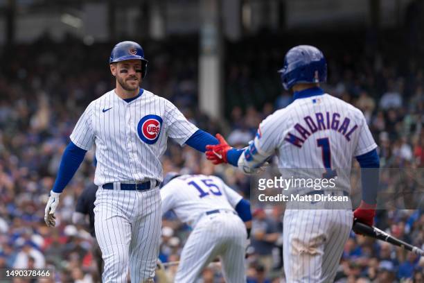 Patrick Wisdom of the Chicago Cubs celebrates a run scored in a game against the Los Angeles Dodgers at Wrigley Field on April 21, 2023 in Chicago,...
