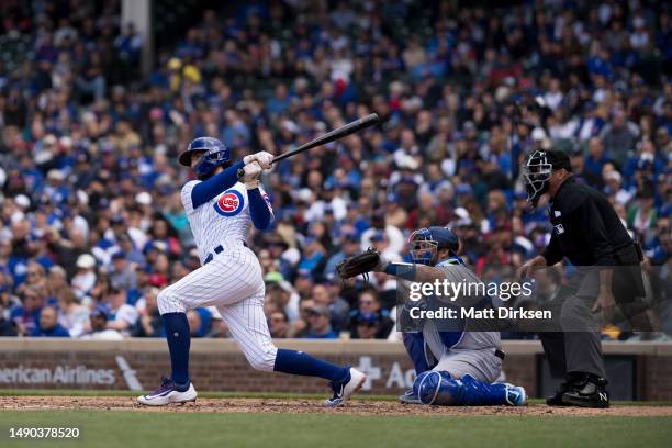 Dansby Swanson of the Chicago Cubs watches the flight of a ball in a game against the Los Angeles Dodgers at Wrigley Field on April 21, 2023 in...