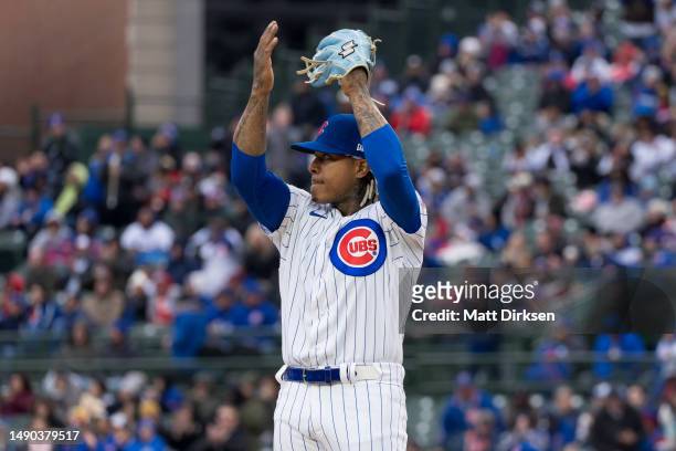 Marcus Stroman of the Chicago Cubs reacts to the crowd as the video board reveals his 1000th career strikeout in a game against the Los Angeles...