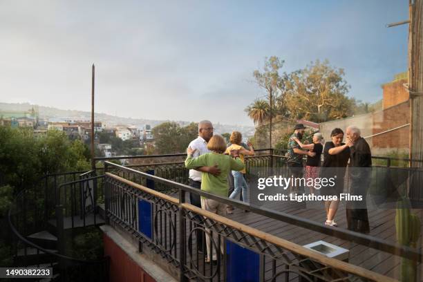 wide shot of multiple older couples ballroom dancing together on patio overlooking skyline - chile skyline stock pictures, royalty-free photos & images