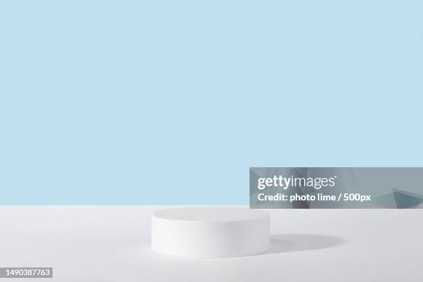 close-up of white container on table against blue background,milan,italy - winners podium imagens e fotografias de stock