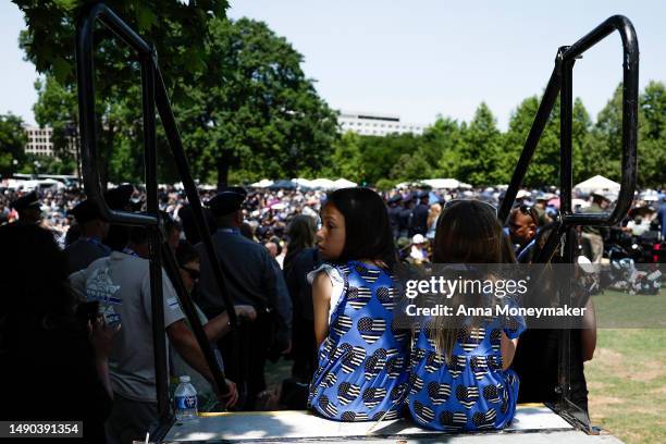 Children listen as a roll call of names of deceased law enforcement officers is read during the National Peace Officers' Memorial Service at the U.S....