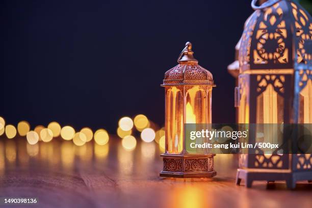 group of arabic candle lantern with glowing light,malaysia - eid greeting stock pictures, royalty-free photos & images