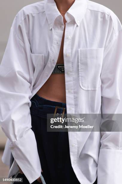 Nadine Berneis seen wearing a Prada denim black logo bra, Diesel 1DR mini denim baby blue handbag, Closed wide leg, dark blue denim belt pants, black...