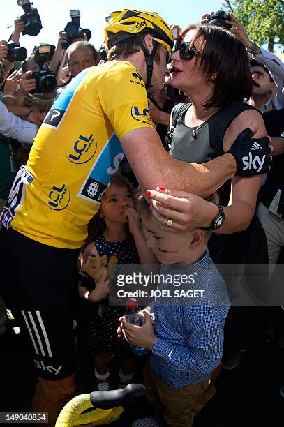 Tour de France 2012 winner, Yellow jersey British Bradley Wiggins, kisses his wife Catherine, flanked by their children, on the Champs-Elysees Avenue...