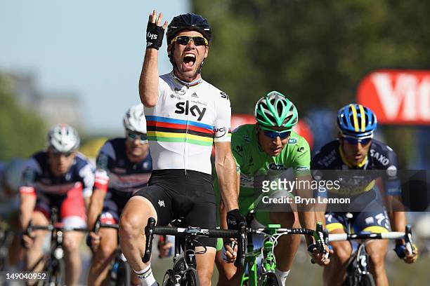 Mark Cavendish of SKY Procycling celebrates as he crosses the finish line to win the bunch sprint during the twentieth and final stage of the 2012...