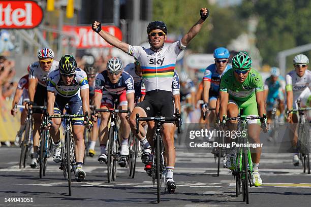 Mark Cavendish of SKY Procycling celebrates as he crosses the finish line to win the bunch sprint during the twentieth and final stage of the 2012...