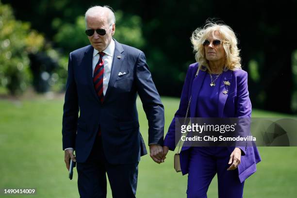 President Joe Biden and first lady Jill Biden walk across the South Lawn as they return to the White House on May 15, 2023 in Washington, DC. The...