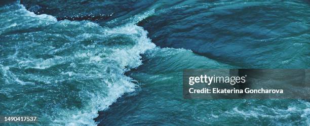 teal banner background of the water surface with a wave - deep ocean stock pictures, royalty-free photos & images