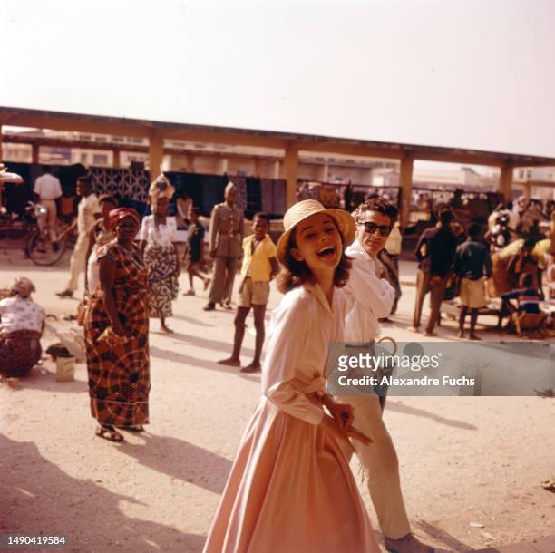 Actress Audrey Hepburn and actor Peter Finch visit the local market at Kisangani, Congo, in 1958.