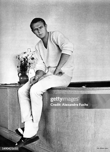 Actor Steve McQueen seats by his hotel in Germany, where he was filming 'The Great Escape' in 1962.