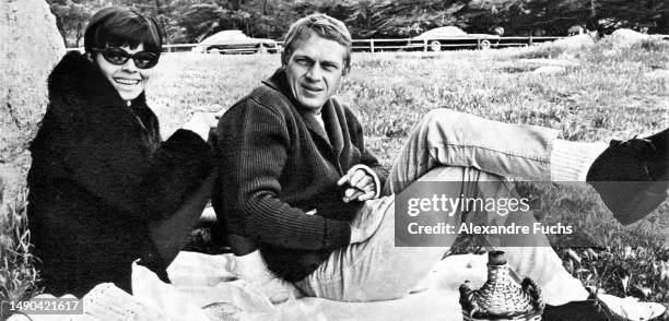 Actor Steve McQueen seats with his wife, actress Neile Adams, in Germany, where Steve was filming 'The Great Escape', in 1962.