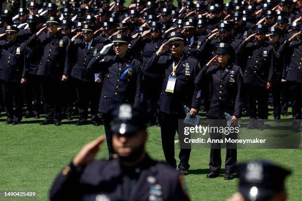 Police officers salute during the playing of the national anthem at the annual National Peace Officers' Memorial Service at the U.S. Capitol on May...