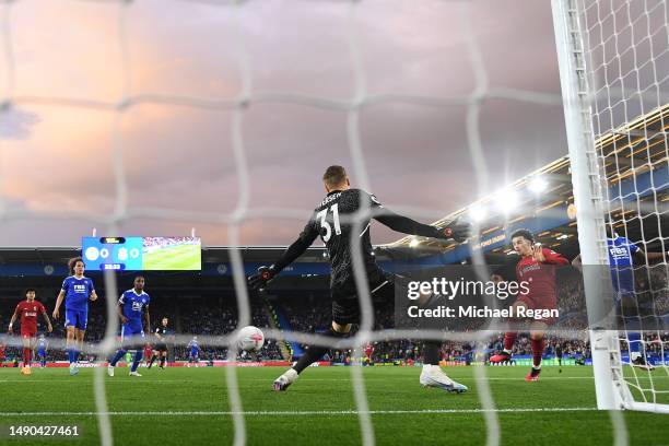 Curtis Jones of Liverpool scores the team's first goal past Daniel Iversen of Leicester City during the Premier League match between Leicester City...