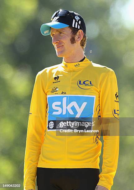 Bradley Wiggins of Great Britain and SKY Procycling celebrates after receiving the maillot jaune on the podium and winning the general...