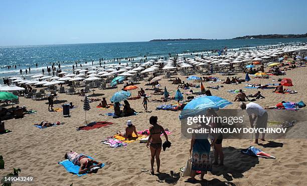 Diana Simeonova People enjoy the sun at the beach of the Black Sea resort of Sunny Beach, near the city of Bourgas on July 22, 2012. Sunbathing,...