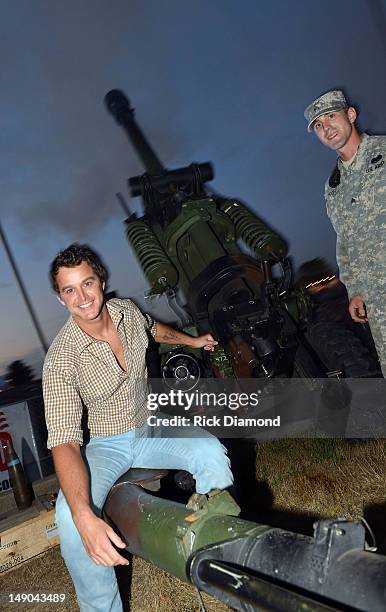 Recording Artist Easton Corbin fires a Howitzer 105mm cannon with the help of the Wisconsin National Guard at Country Thunder - Day 3 on July 21,...