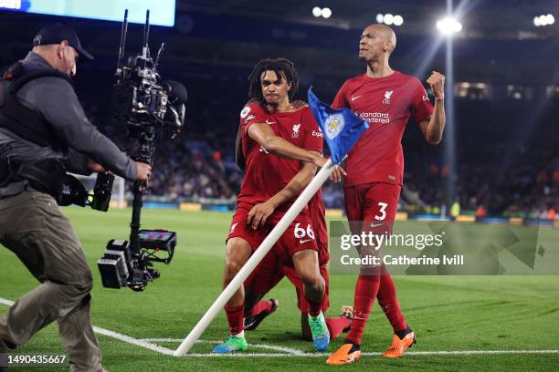 Trent Alexander-Arnold of Liverpool celebrates with Fabinho after scoring the team's third goal during the Premier League match between Leicester...