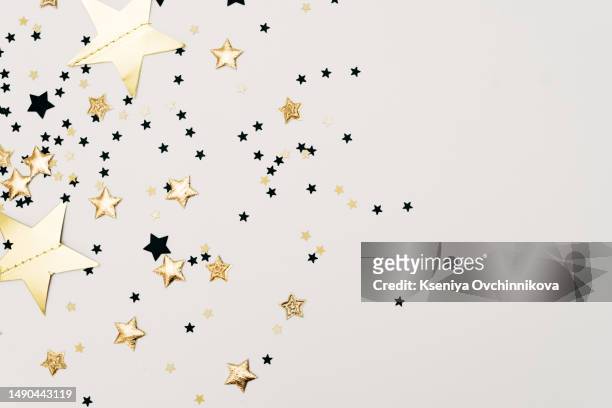 golden confetti isolated on black background - glitz and glam holiday event stock pictures, royalty-free photos & images