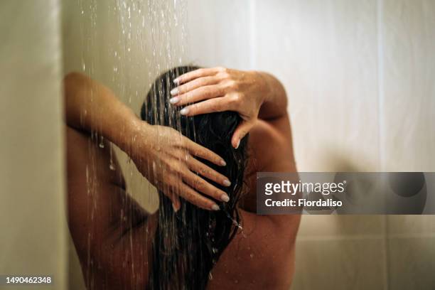 woman in the hotel room having a shower - women washing hair stock pictures, royalty-free photos & images