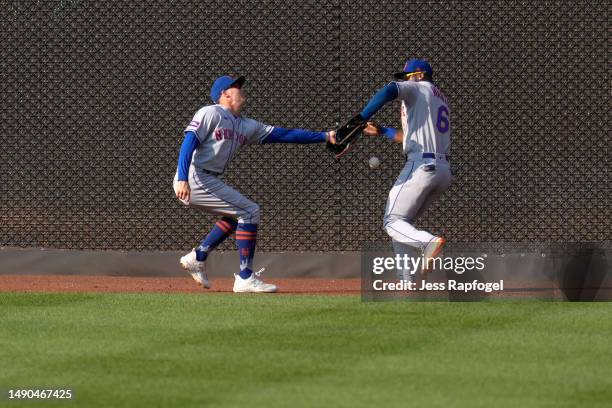 Brandon Nimmo of the New York Mets and teammate Starling Marte struggle with a catch against the Washington Nationals during the seventh inning at...