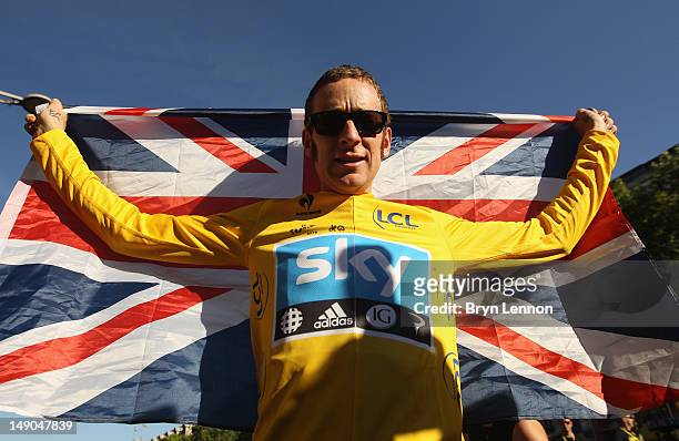 Bradley Wiggins of Great Britain and SKY Procycling celebrates on a processional lap after winning the 2012 Tour de France after the twentieth and...