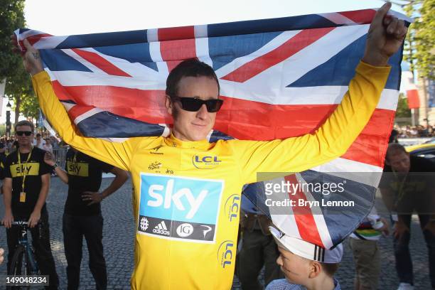 Bradley Wiggins of Great Britain and SKY Procycling celebrates on a processional lap after winning the 2012 Tour de France after the twentieth and...