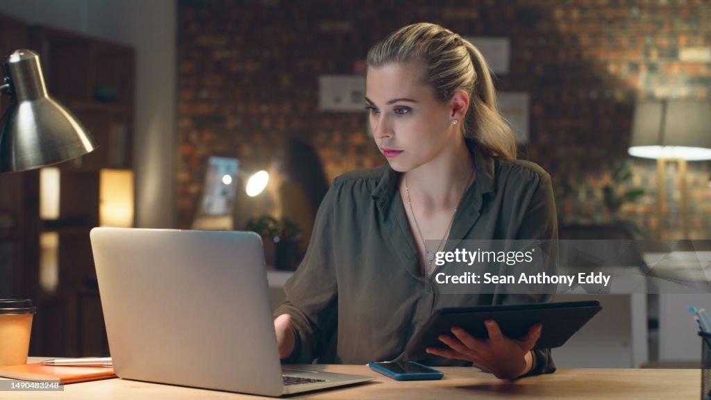 Night, tablet or businesswoman with laptop research overtime typing a digital marketing strategy. Email, SEO technology or female employee networking online late for proposal deadline on internet