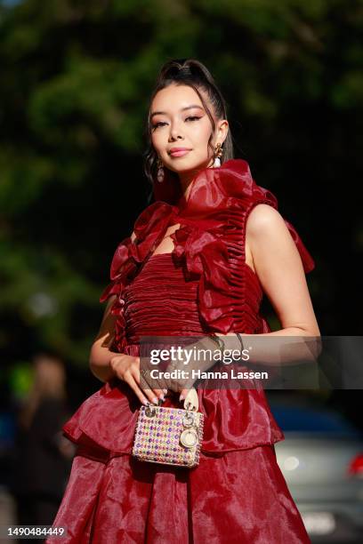 Tara Milktea wearing Aje red dress and Dior mini bag at Afterpay Australian Fashion Week 2023 at Carriageworks on May 16, 2023 in Sydney, Australia.