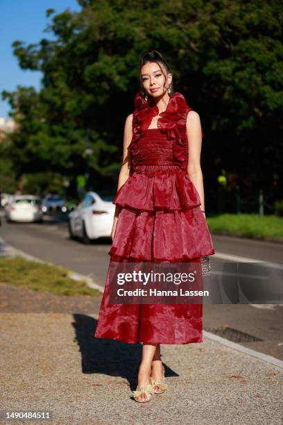 Tara Milktea wearing Aje red dress and Dior mini bag at Afterpay Australian Fashion Week 2023 at Carriageworks on May 16, 2023 in Sydney, Australia.
