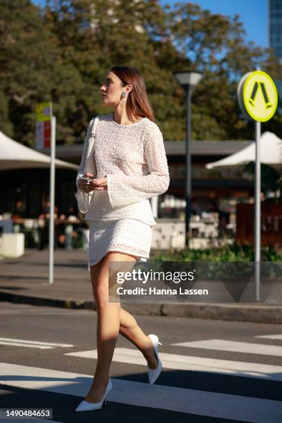 Holly Lyle wearing white pearl detailed Aje top and mini skirt at Afterpay Australian Fashion Week 2023 at Carriageworks on May 16, 2023 in Sydney,...