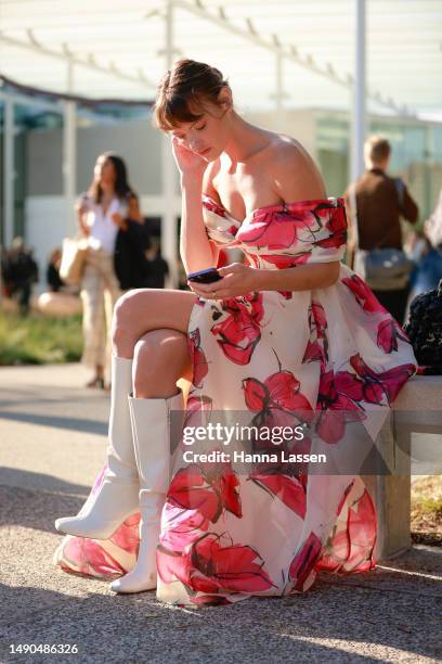 Montana Cox wearing pink floral Aje dress and white boots at Afterpay Australian Fashion Week 2023 at Carriageworks on May 16, 2023 in Sydney,...