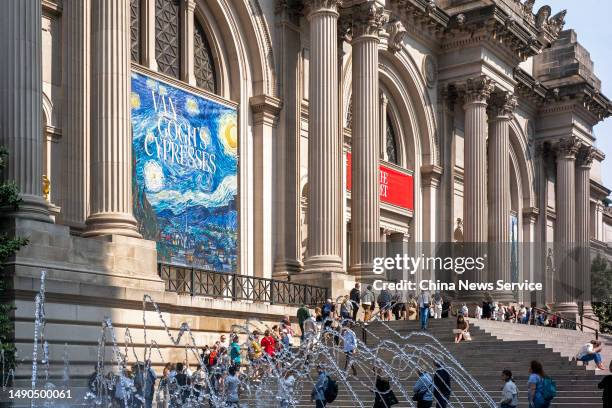 People queue up to enter the Metropolitan Museum of Art to for the media preview of "Van Gogh's Cypresses" Exhibition on May 15, 2023 in New York...