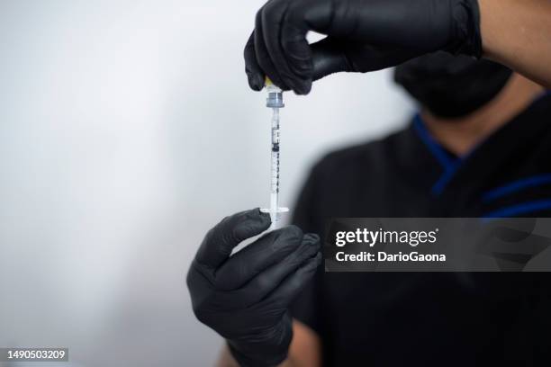 preparing syringe with botox - botoxinjektion bildbanksfoton och bilder