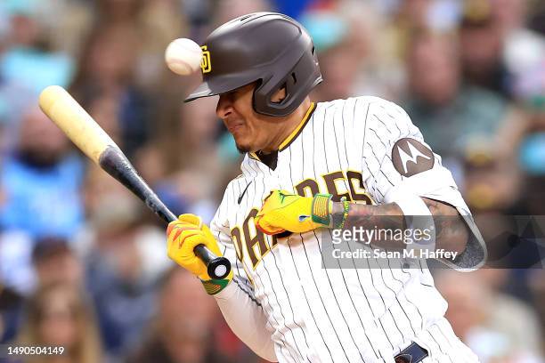 Manny Machado of the San Diego Padres is hit by a pitch on the wrist during the second inning of a game against the Kansas City Royals at PETCO Park...