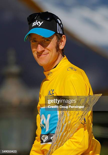 Bradley Wiggins of Great Britain and SKY Procycling looks on after receiving the maillot jaune on the podium and winning the general classificication...