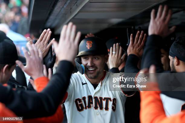 Michael Conforto of the San Francisco Giants is congratulated by teammates in the dugout after he hit a three-run home run against the Philadelphia...