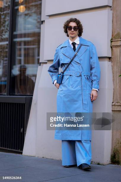 Guest wearing blue Anna Quan trench coat at Afterpay Australian Fashion Week 2023 at Carriageworks on May 16, 2023 in Sydney, Australia.