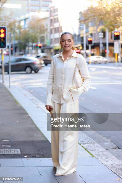 Olympia Valance wearing Anna Quan silk shirt and wide pants and Bulgari white bag at Afterpay Australian Fashion Week 2023 at Carriageworks on May...