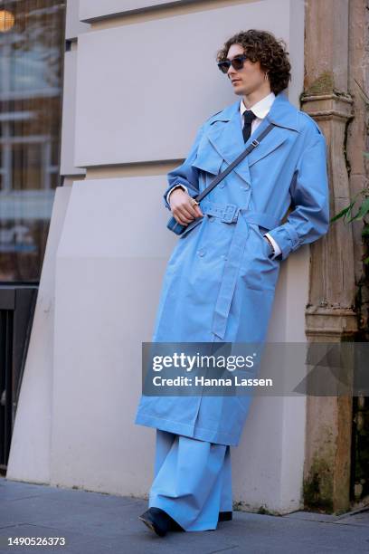 Guest wearing blue Anna Quan trench coat at Afterpay Australian Fashion Week 2023 at Carriageworks on May 16, 2023 in Sydney, Australia.