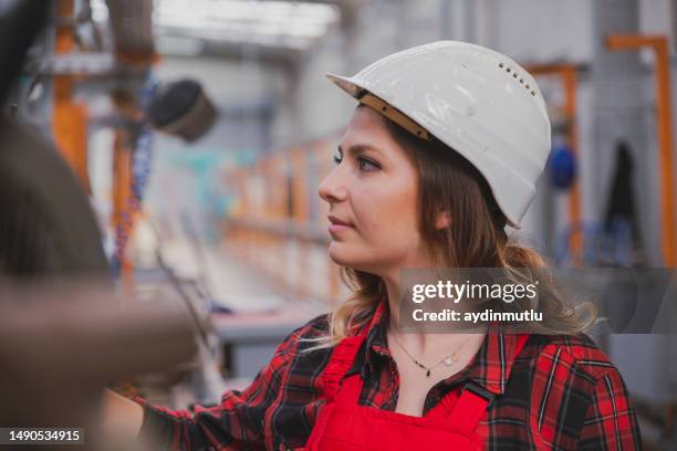apprentice engineer young woman working with cnc machine in factory - injection molding stock pictures, royalty-free photos & images