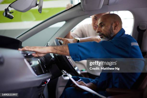 asian car mechanic examines car interior with asian male customer - car ac check stock pictures, royalty-free photos & images