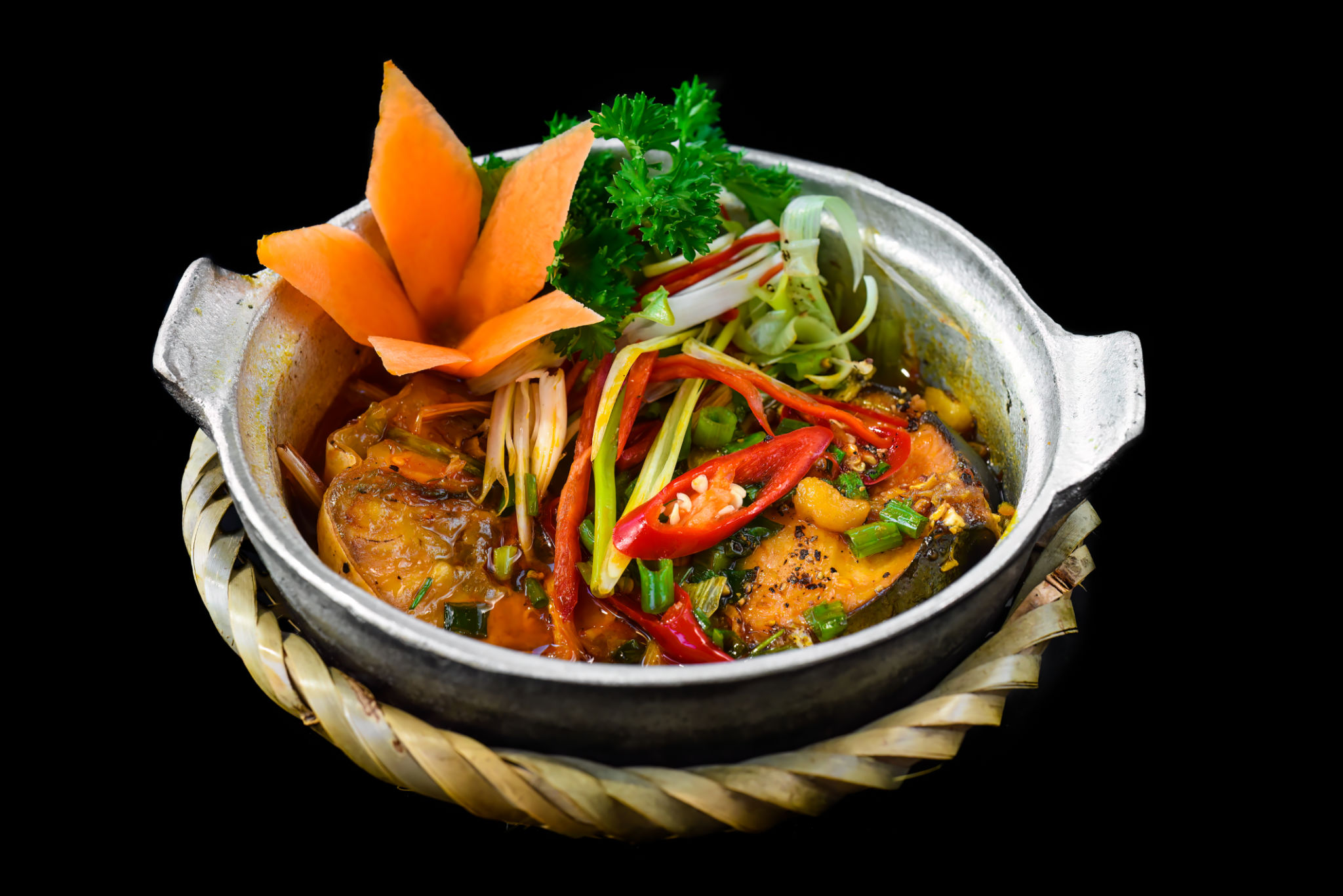 Vietnamese fried Mackerel fish with sauce on black background Vietnamese fried Mackerel fish with sauce on black background