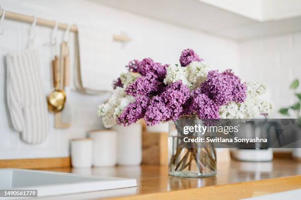 lilac flowers in vase on wooden countertop - purple lilac stock pictures, royalty-free photos & images