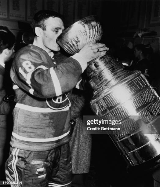 The Montreal Canadiens' Marcel Bonin drinks from the Stanley Cup following his team's win over the Toronto Maple Leafs at the Montreal Forum in...