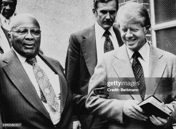 President Jimmy Carter leaves the Zion Baptist Church in Washington with Reverend Martin Luther King Sr on September 25th 1977. King was guest...