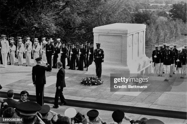 Member of the honour guard salutes US President Jimmy Carter after he placed a wreath at the Tomb of the Unknown Soldier during a Veterans Day...