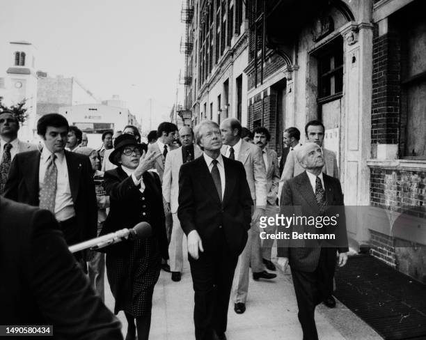 President Jimmy Carter visits the South Bronx in New York, accompanied by Patricia Harris , Secretary of Housing and Urban Development, and Mayor...