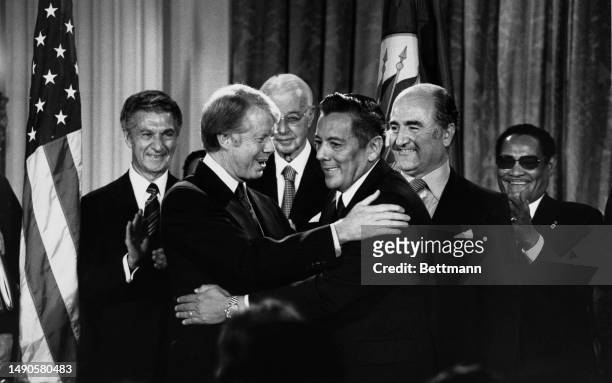 President Jimmy Carter and Panamanian leader General Omar Torrijos embrace each other after signing the Panama Canal Treaty at the Organization of...